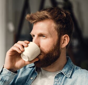 bărbat care bea o ceașcă de cafea